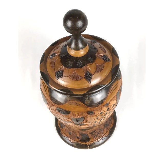 A really unique work of art. Floral carved design on each side. One side has some geometric design happening. The dark...