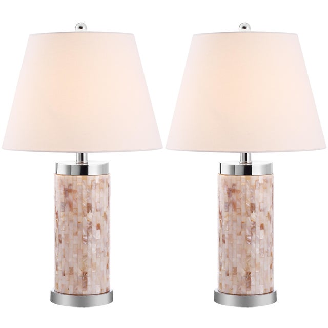 a elegant column lamp with silver bands capping a base of capiz shell mosaic in pearly tones of white and beige,casts a...