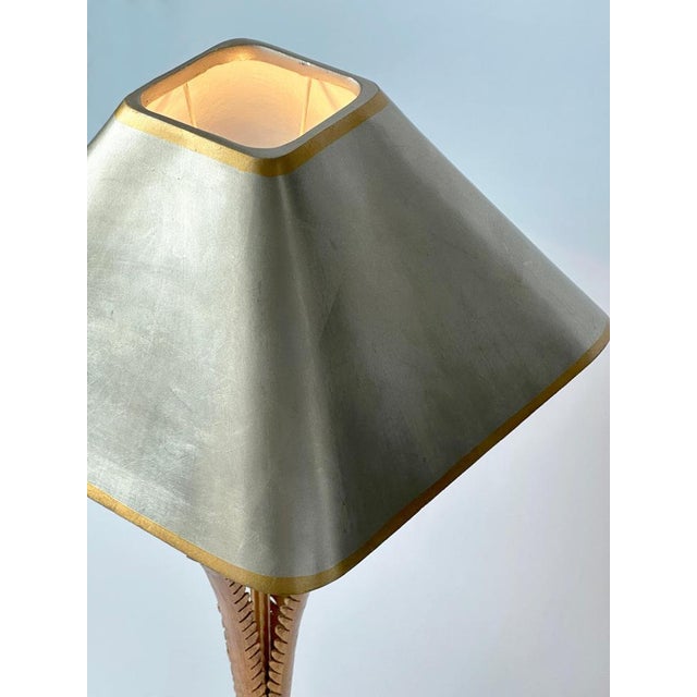 A gilded palm tree lamp by lam lee for leeazanne, usa, circa 1980. This glamorous design blends art deco sensibilities...