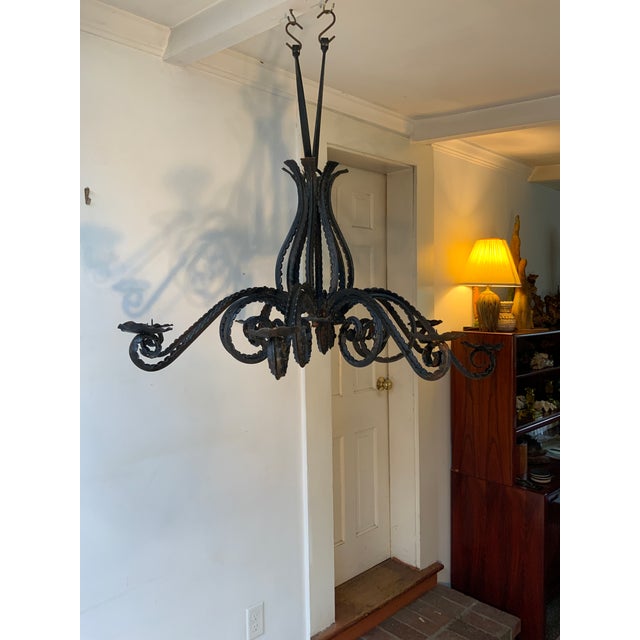 Rustic Black Wrought Iron Chandelier With Sweeping Foliated Arms and 8 Cupped Candle Holders. Has not been wired for...