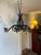 Rustic Black Wrought Iron Chandelier With Sweeping Foliated Arms and 8 Cupped Candle Holders. Has not been wired for...