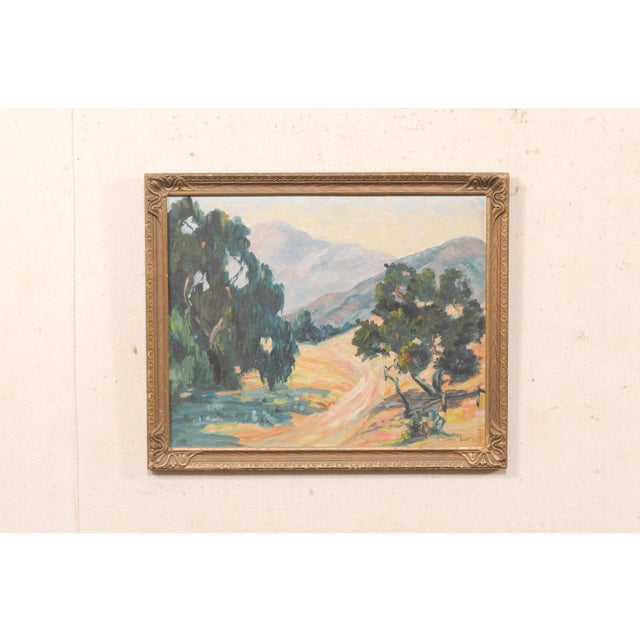 A framed American landscape painting from the mid-20th-century. This mid-century artwork depicts a tranquil rural scene,...