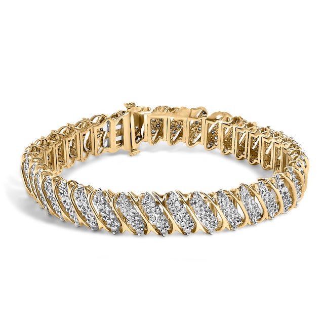 A ribbon of sunlit elegance, this bracelet traces the wrist with fluid S-curves that cradle leaflike stations, each one...