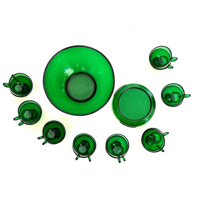 Perfect for any festive occasion, this vintage green glass punch bowl set will add a stylish flare to your special event....