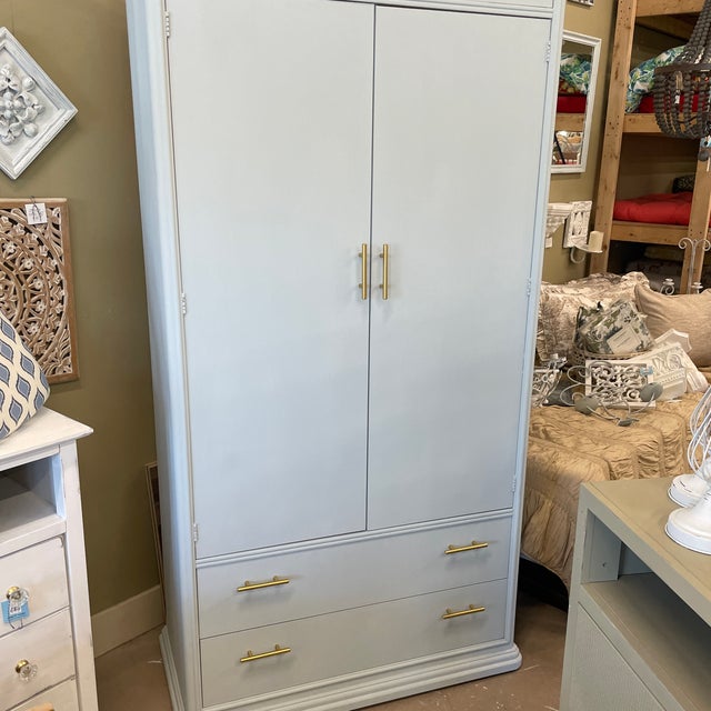 Large scale vintage Thomasville wardrobe in a very neutral muted gray matte finish with updated gold hardware. Very solid...