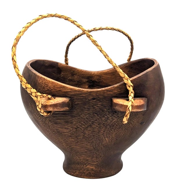 Offered is a vintage Late 20th Century carved Ikoro wood basket / bowl with rope handles, a typical ware created by the...