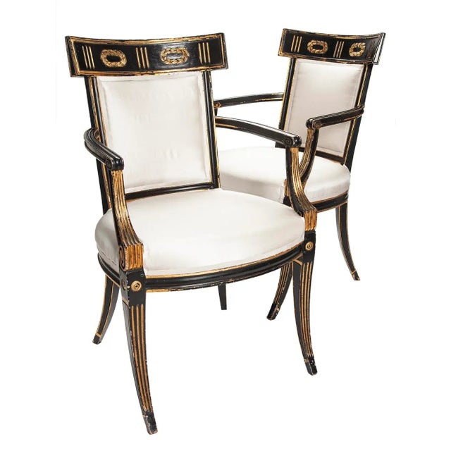 Early 19th Italian Regency, Neoclassical armchairs with finely carved details accented in gilt finish over the hand carved...