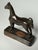 Bronze overlay on cast iron make up this small horse statue figurine. A novelty item once used as a tour souvenir it has a...