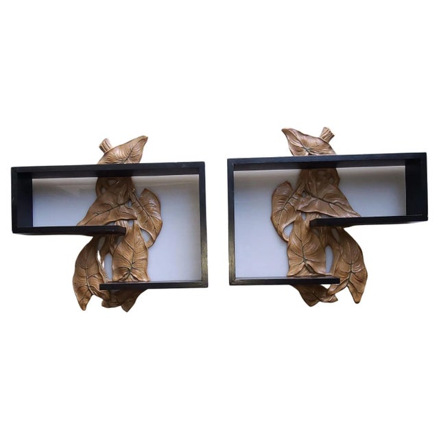 Midcentury floating wall shelf with black lacquer finish and hand-carved leaf sculpture in the center, circa 1950.
