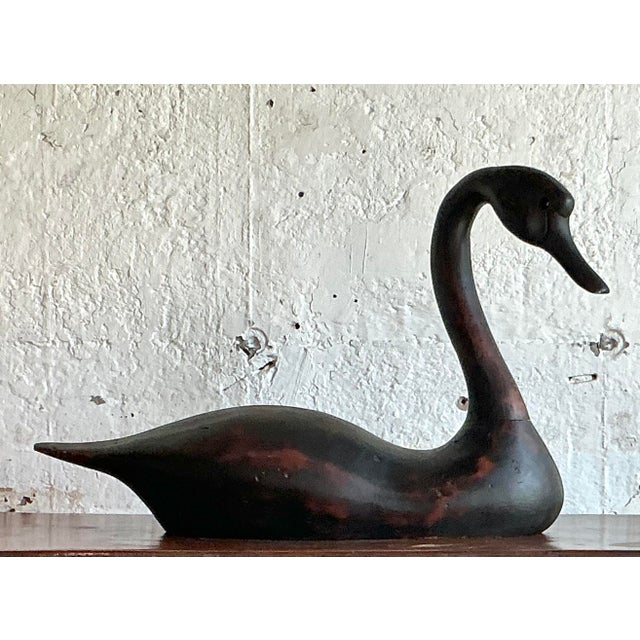 Capture the serene elegance of nature with this stunning, life-size swan sculpture. Expertly hand-carved from solid wood...