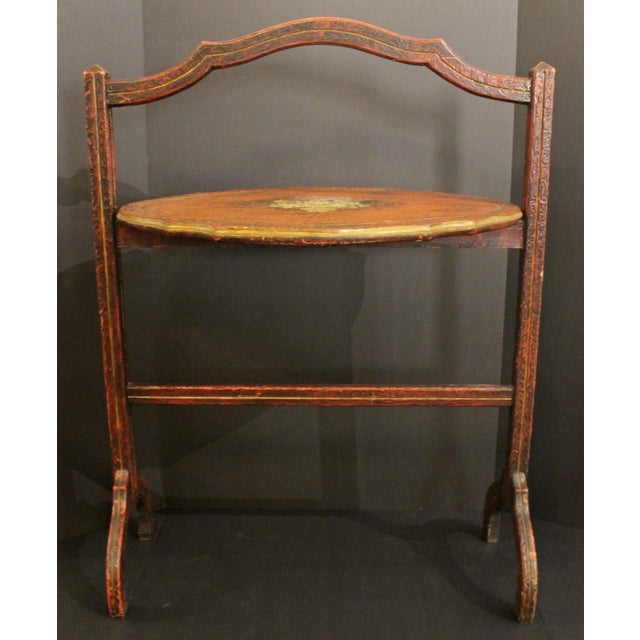 Circa 1920s tilt-top side table, Anglo-American. Burnt Chinese red ground; handpainted urn of flowers; impressed...
