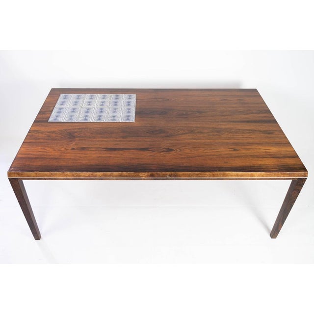 Coffee table in rosewood with tiles, designed by Johannes Andersen and manufactured by Silkeborg Furniture from the 1960s....