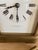 This antique clock has the original white enamel dial with Roman numerals and spear-like hands. It is signed W.H. Glenny...