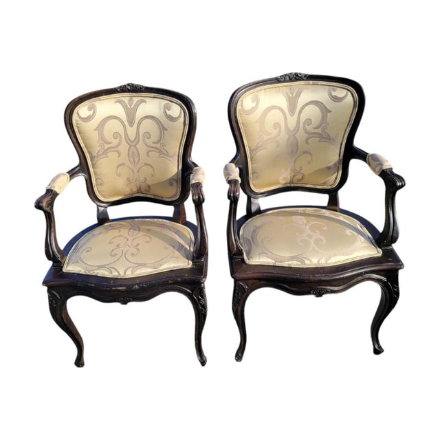 Pair of 1940s French Provincial armchairs in maple with ebony color finish. Carved frames in Louis XV style with cabriole...