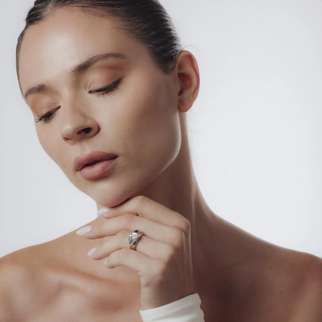 This Mid-Century ring from the 1950’s is crafted in 18k white gold and set with five square cut rubies totaling...