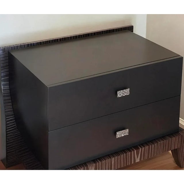 Exceptional pair of Arteriors Home nightstands in espresso lacquer framed by sculptural Macassar-style edge detailing....