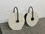 Design Plus Gallery presents a Pair of Modern Wall Sconces. The sconces have a white, round partition between the light...