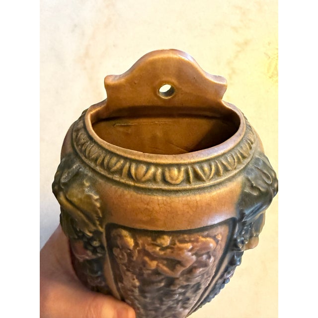 The Antique Roseville Florentine Large Wall Pocket from 1924 is a charming piece of decorative pottery that showcases the...