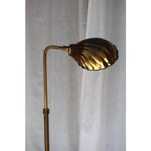 A beautifully sculptural vintage brass floor lamp in the style of Frederick Cooper, featuring the signature clamshell...