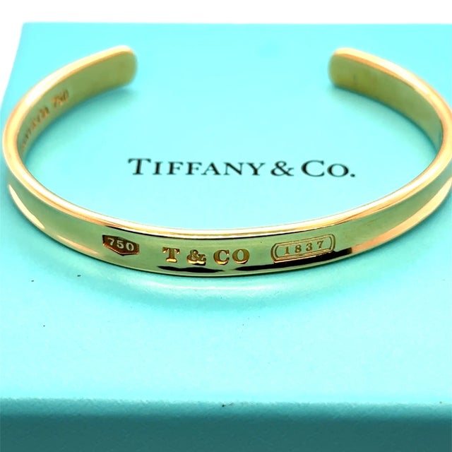 A rare and collectible vintage Tiffany & Co. cuff bracelet, crafted in luxurious 18ct yellow gold, celebrating the iconic...