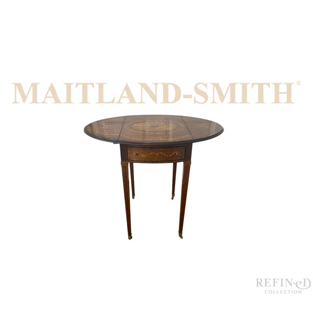 Elegant vintage drop-leaf side table by Maitland-Smith, featuring a refined oval form, slender tapered legs, and classic...