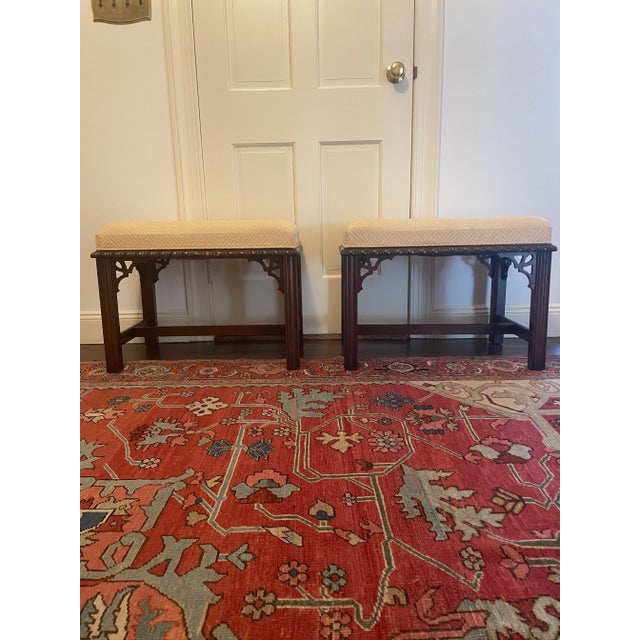 Great pair of mahogany stools in the Chippendale style with carved trim and lattice in corners. They have fluted legs and...