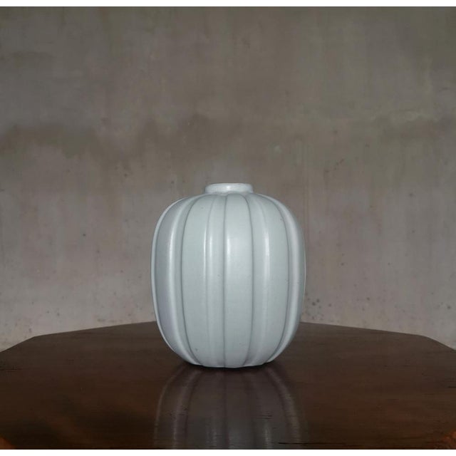 Rare Fluted Earthenware Vase by Vicke Lindstrand for Upsala Ekeby. Sweden, 1930s. A rarely seen white earthenware vase...