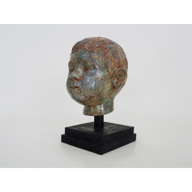 Sculpture of a child's face in glazed sandstone, Italian sculptor. 70s 80s Very beautiful child's face sculpted in...