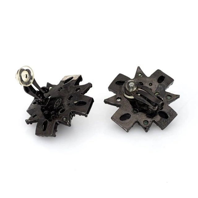 This is part of Chairish’s Costume Jewelry assortment. Pre-owned Chanel large black cross earrings (circa 2011). The...