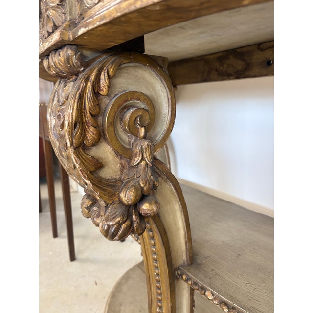 A sophisticated early 19th-century French "Demi-Lune" console table with both Neoclassical and Louis XVI influences,...