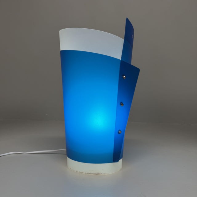 A playful italian design lamp with a distinctive shape and a beautiful deep blue colour. dimensions: h 36 × ø 20 cm this...