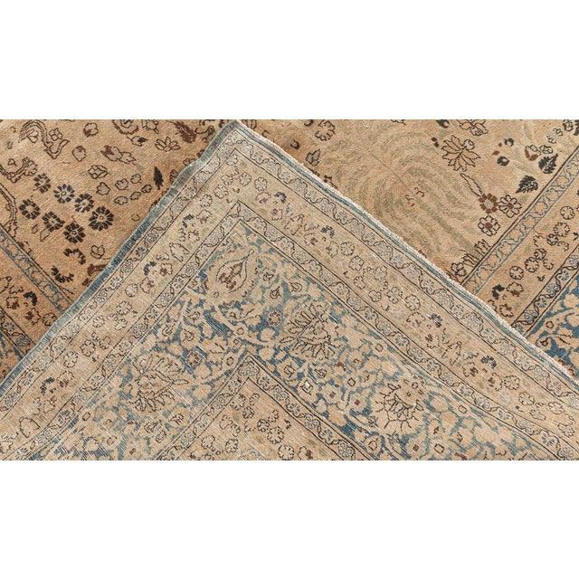 Opulent and imperial, this antique Persian rug is a flagship example of the incredible Tabriz craftsmanship. The weaving...