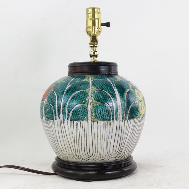 This antique table lamp is expertly crafted from an authentic porcelain vessel featuring the traditional and highly...