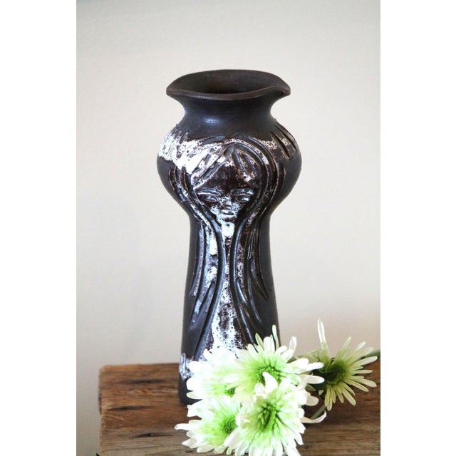 This mid-century vase screams Italian pottery, no? Each side has the face of a woman with long hair, the carvings done in...