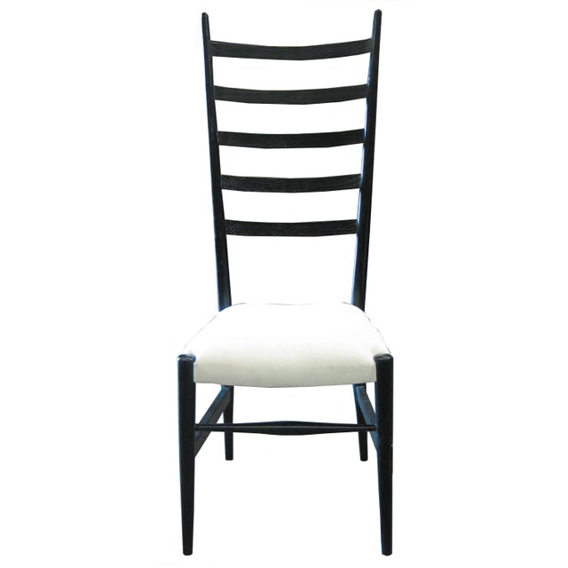 A dramatic, oversized ladder back brings an unexpected sense of whimsey to this otherwise classic armless dining chair....