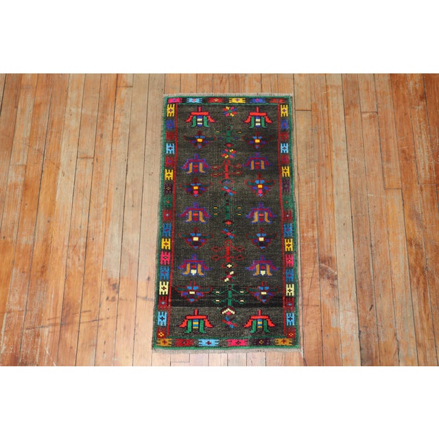 Quirky vintage Turkish Anatolian floral rug featuring vibrant colors on a brown ground. Measures: 1'6' x 2'10".