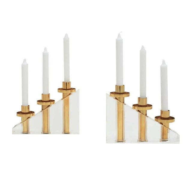 Pair of sculptural candelabras made of solid methacrylate and brass. France, 1970.
