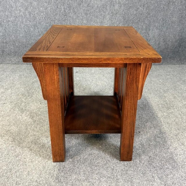 This oak Mission style side table features clean, rectilinear lines with slatted sides and a sturdy, handcrafted feel true...