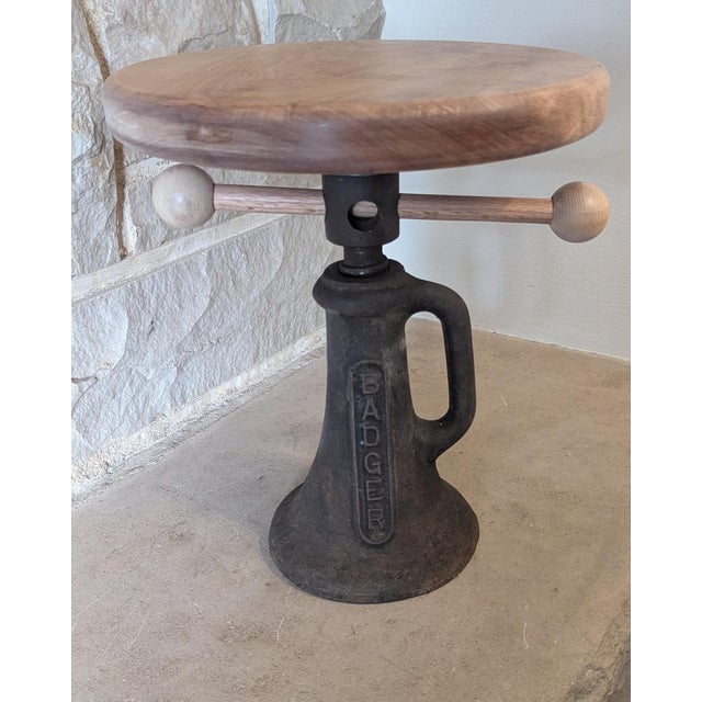 An old railroad screw jack table. I belieive the top is cherry wood. The cast iron jack is from the mid 20th centry....