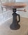 An old railroad screw jack table. I belieive the top is cherry wood. The cast iron jack is from the mid 20th centry....