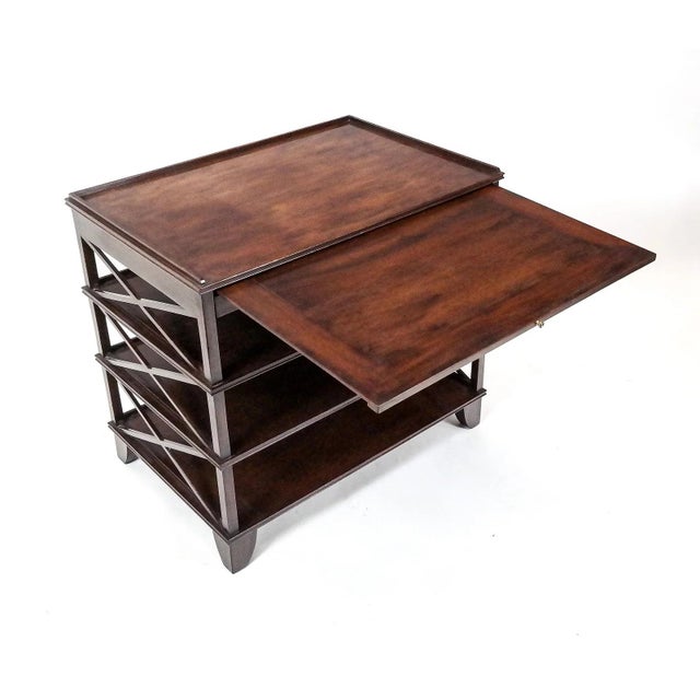A Regency style four tier mahogany side table with a banded pullout surface. The table sides feature a triple X form...