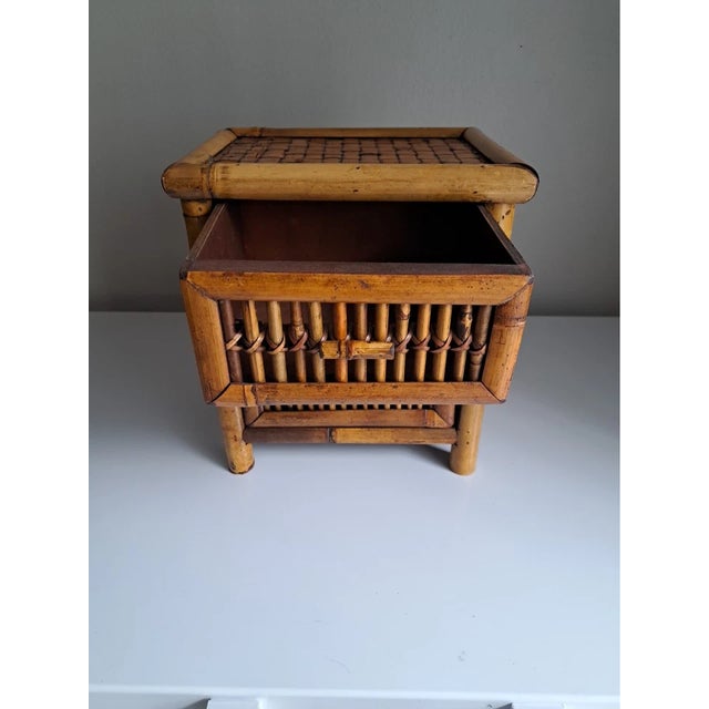 Add natural charm to your home with this vintage bamboo and wicker rattan accent table. Featuring two spacious drawers...