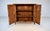 A late Victorian Tortoise Bamboo two door console cabinet with original painted textured grass cloth surround and two...