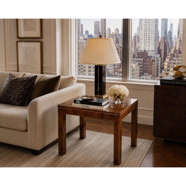 An elegant vintage burl wood waterfall side table featuring rich figured veneer, clean lines, and subtle brass inlay...