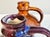 A pair of handcrafted stoneware vases with an unknown signature. The pair is striking for its vibrant glaze: one vase...