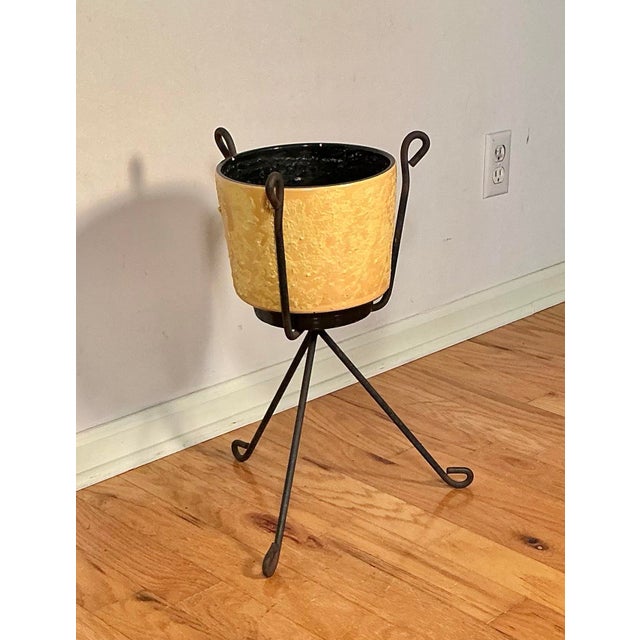 Classic 1950's Mid-Century Modern plant stand design, featuring popular atomic-era and industrial elements. The stand is a...