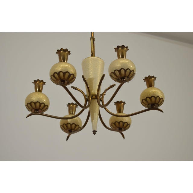 Six-light Murano glass chandelier with elegant gold inclusions, featuring finely crafted spherical diffusers and a...
