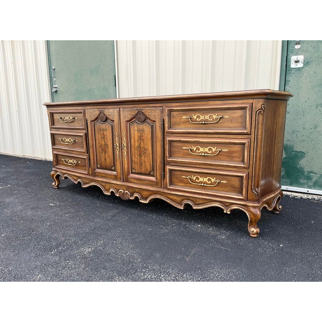 A long triple dresser from Drexel Heritage's Brittany Collection. This iconic collection is defined with strong French...