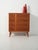 Nordic mahogany chest of drawers with understated lines, slender legs, and classic brass handles. Scandinavian chest of...