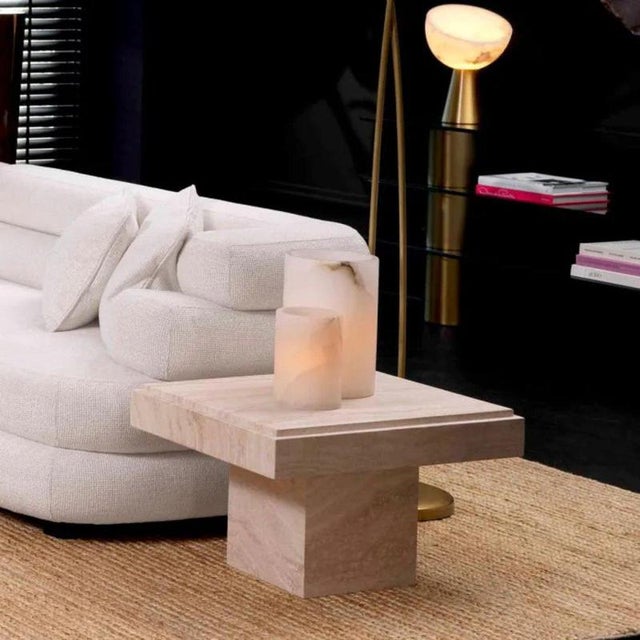 Travertine side table with a rectangular silhouette and substantial stone construction. Made entirely from natural...